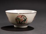 a white bowl with a dragon on it on a table
