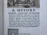 an old book with a picture of a coat of arms on it