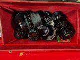 many cameras in a red box on a table