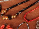 many necklaces and bracelets laid out on a table