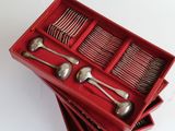 a lot of spoons and forks in a red box