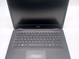 the dell laptop is open and ready to be used on the desk