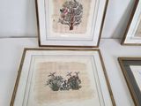 three framed pictures of birds and flowers on a white surface