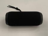 an image of a black speaker sitting on top of a white table