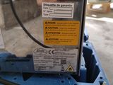 a close up of a blue machine with a sticker on it