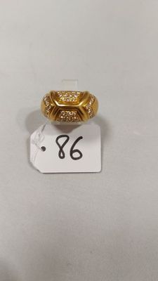 gros plan d'une bague en or sur une surface blanche