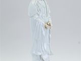 statue of a woman holding a flower in her right hand