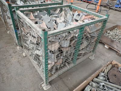 many pieces of metal in a cage on the ground