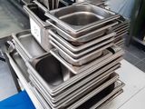 several trays of food are stacked on top of each other in a kitchen