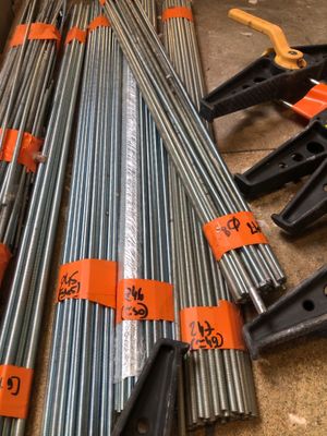 several different types of steel pipes are laid out on the floor