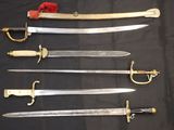 six different types of swords are displayed on a black cloth