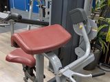 an image of a gym room with a row of exercise equipment