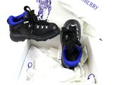two pairs of black shoes in a box with blue accents