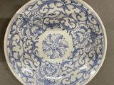 a close up of a blue and white plate on a table