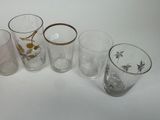 five glasses sitting next to each other on a table