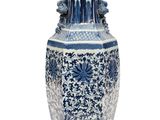 a blue and white vase with a floral design on it