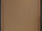 an old photo of a brown piece of paper on a black surface