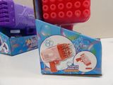 purple and red plastic toy gun and a pink plastic toy gun in a box