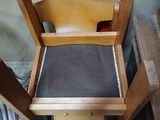 a wooden chair with a black seat and a brown seat
