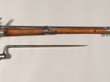 a toy gun and a knife on a white surface