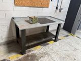 a small table with a box on it in a jail cell