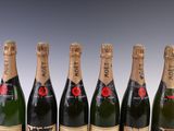 six bottles of champagne are lined up in a row