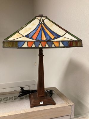 a close up of a lamp on top of a wooden table