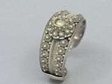 a close up of a silver ring with a stone in it