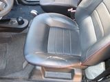 a picture of the inside of a car with black leather seats