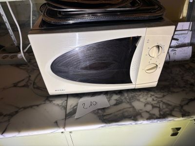 a microwave sitting on top of a counter with a price tag on it