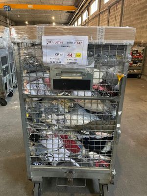 a metal cart with a lot of shoes on it in a warehouse