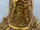 a close up of a gold vase on a table