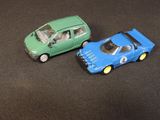 two toy cars sitting next to each other on a table