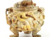 an image of a very old looking vase with a frog on it