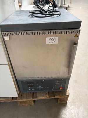 a small refrigerator sitting on a pallet in a warehouse