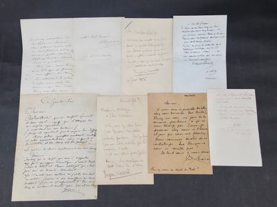 several old letters are on a table with a black background