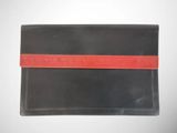 a black and red wallet sitting on top of a white table