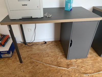 a computer desk with a printer on top of it