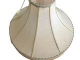a white lamp shade with a pink lining on it