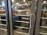 two large glass doors that are open in a store
