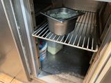 a pot and a pan in the open door of an oven