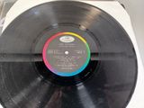 an old record with a rainbow on it sitting on top of a table