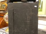 a small black cabinet sitting on a table in a room