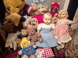 a lot of stuffed animals and dolls on the floor