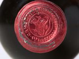a close up of a wine bottle with a red label