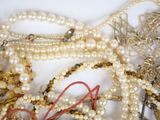 a pile of pearls and other jewelry on a table