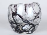 a glass vase with a black and white design on it