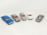 several toy cars are lined up in a row on a white surface