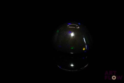 an image of a black vase with colored lights on it