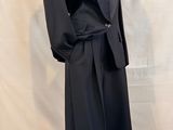 an image of a mannequin wearing a black suit and tie